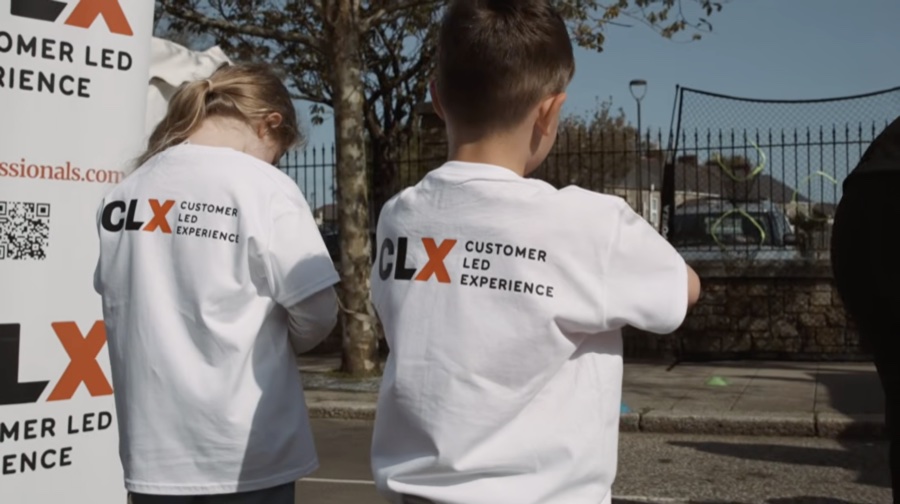 Young supporters wearing CLX Customer Led Experience shirts
