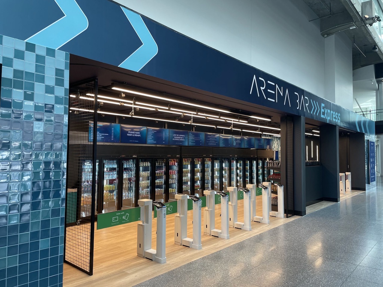 Self-serve outlet at Rod Laver Arena with entry gates and digital menu screens